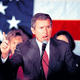 Bush lashes out at critics who "insist on harping on bygones when Americans are hurting today."